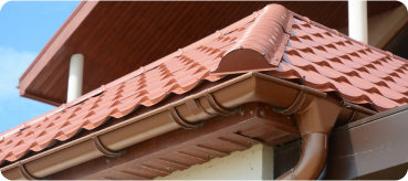 Inicio 3 Top Tejados Barcelona tiled roof against blue sky with clouds idea background with space text ecofriendly traditional roofs home 1 - Top Tejados Barcelona